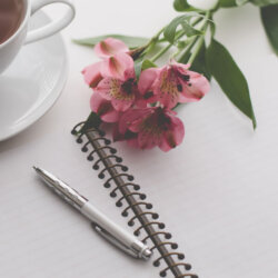 flowers and writing pad with pen unsplash_carolyn-v